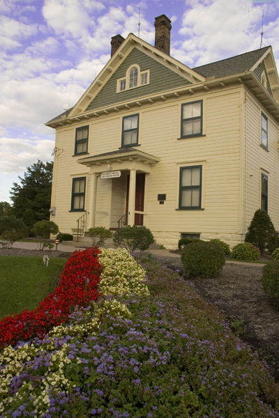 Bath Township Museum with flowered landscaping and a view of the front exterior of the building.